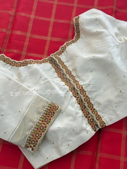 An off-white blouse with a simple but elegant embroidered border.