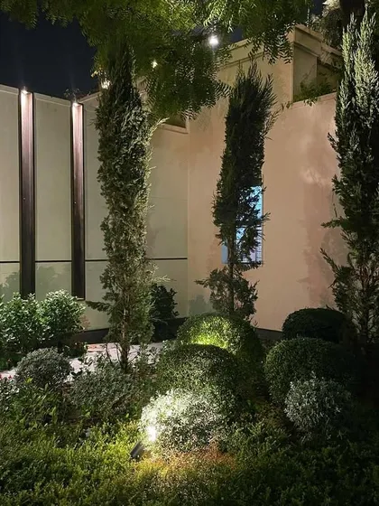 The right lighting transforms a garden at night. For this farmhouse in Chattarpur, I used a combination of uplights and spotlights to highlight the sculpted shrubs and trees, creating an elegant and secure ambiance after dark.