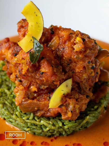 A detailed look at the Prawn Vepudu, garnished with toasted coconut flakes. This dish is a celebration of coastal Indian flavours, presented with contemporary flair.