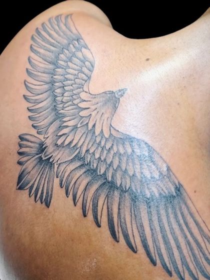 Another angle of the eagle tattoo, highlighting the shading and detail in the wing feathers.
