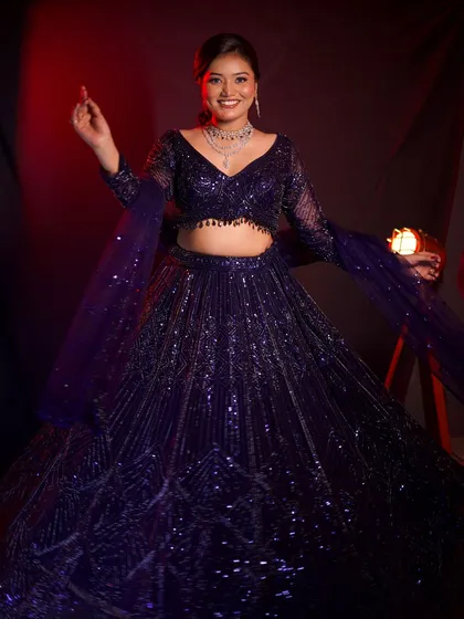 Perfect for a cocktail party or sangeet night, this deep blue sequined lehenga is all about glamour. The way it sparkles makes it a fantastic rental choice for an evening of dancing.