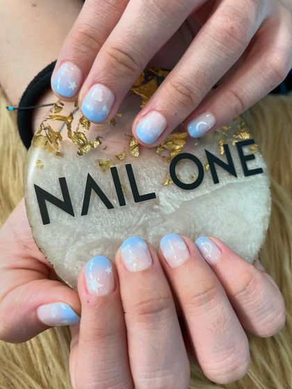 A closer look at the sky-inspired nail art. This design on short, rounded nails is perfect for a subtle yet imaginative look.