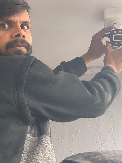 A close-up of our technician fitting a modern security camera. We pay attention to every detail to ensure a secure and lasting installation.