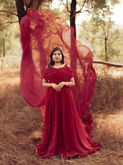A full view of my versatile red trail gown. Its elegant design and long, flowing train make it a popular rental choice for pre-wedding, maternity, and event photoshoots.