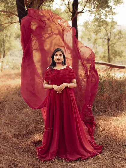 A slightly different angle shows the versatility of the flying train. Here, the fabric is tossed to create a wave of color and motion behind the mom-to-be, adding energy to the portrait.