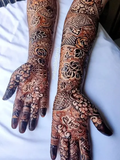 A gorgeous bridal design that incorporates personalized name details within a floral and paisley framework.