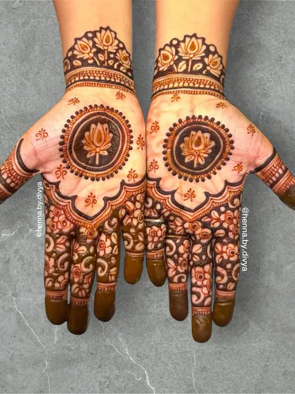 A beautiful lotus mandala design. The central lotus is surrounded by intricate floral patterns that cover the palm, creating a full and symmetrical look.