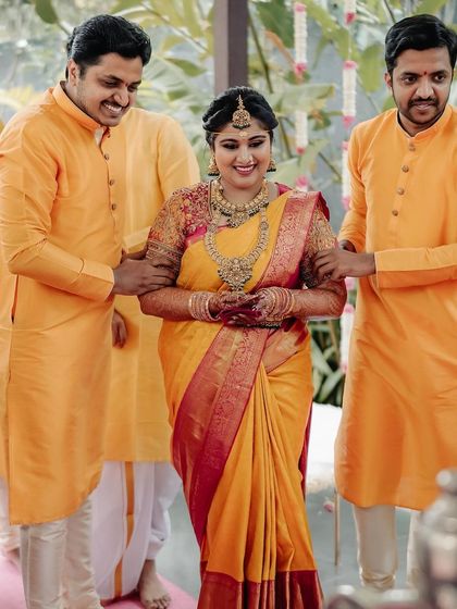 The bride's grand entrance, escorted by her brothers under a custom floral canopy. This is a moment filled with family love and tradition, and we ensure it's as beautiful as she dreamed.