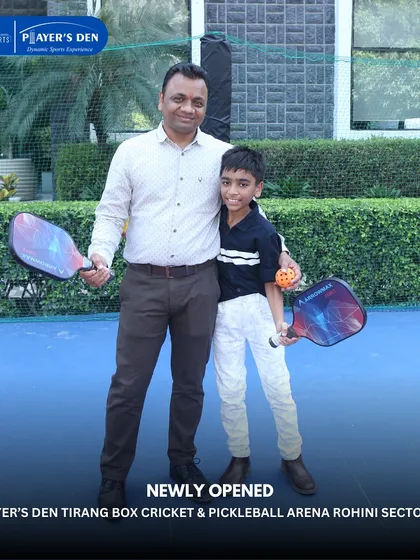 A father and son duo ready for a game of pickleball at our Rohini arena. It's a fantastic sport for families to enjoy together across different generations.