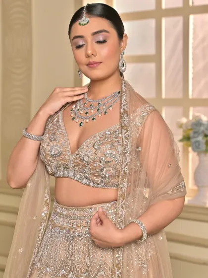 This close-up shows the soft, peachy tones on the eyes and the radiant skin finish. It's a look that is both glamorous and effortlessly beautiful.