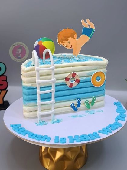 A fun pool-themed half-birthday cake for little Aarush, celebrating "halfway to one" with a splash!