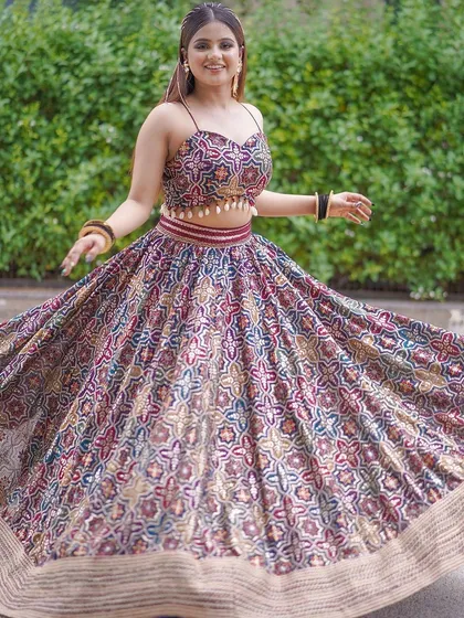 This printed, multi-color lehenga with a spaghetti-strap top is a fun and modern choice for a Mehendi or Haldi shoot. The twirling shots show its beautiful movement.
