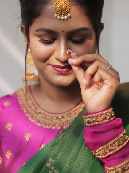 A close-up showing the delicate nose ring and the soft, blended eye makeup.