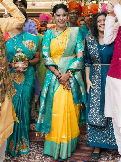 A beautiful Maharashtrian bride making her entrance, surrounded by family.