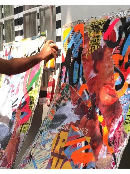 My work isn't just on streets. This piece is a more complex style, mixing wheat-pasted posters, spray paint, and different layers on a canvas. It’s about pushing the boundaries of traditional graffiti and experimenting with new forms.