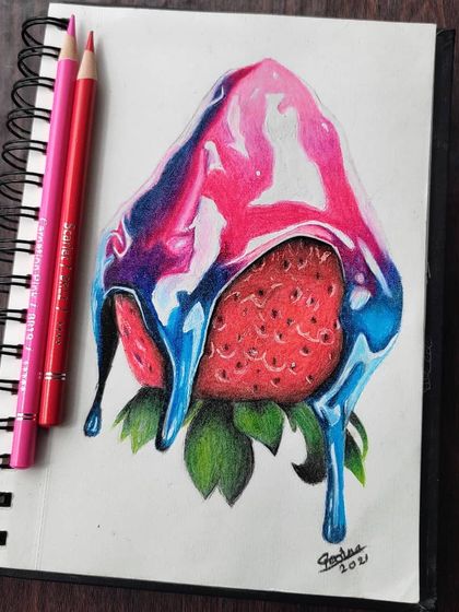 The strawberry drawing in my sketchbook, shown with the pencils used to create the vibrant colors.