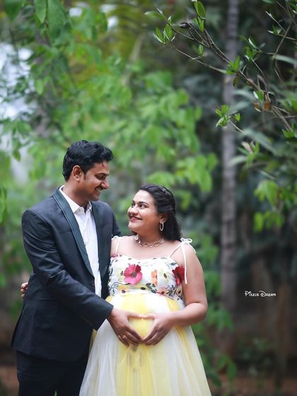 A romantic outdoor couple's portrait, with the mom-to-be in our yellow and white floral gown.