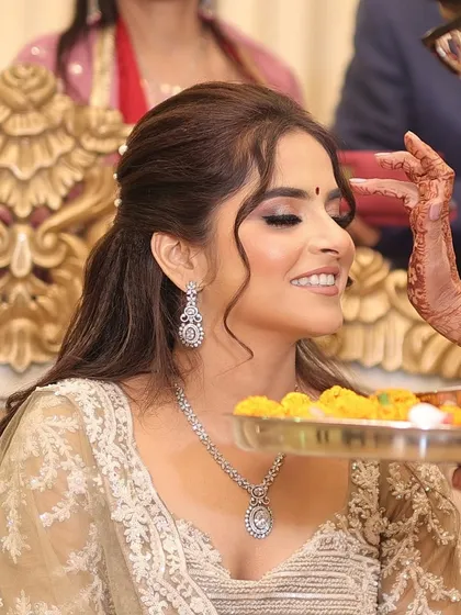 A beautiful traditional moment during the engagement ceremony. Her makeup remains perfect throughout the rituals.