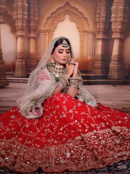 A seated portrait showing the bride in a traditional pose, embodying timeless grace.