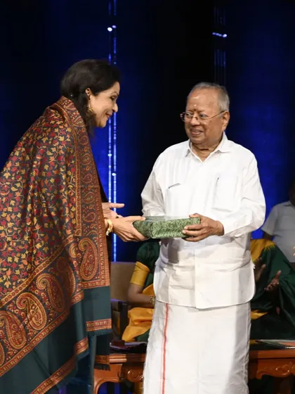Receiving a token of appreciation from a senior member of the Krishna Gana Sabha. The warmth and respect from such venerable institutions mean a great deal.