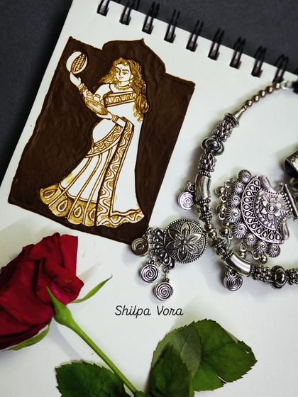 A creative sketch of a woman celebrating Karwa Chauth, drawn with henna on a notepad. This is part of my design process for creating unique figurative art.