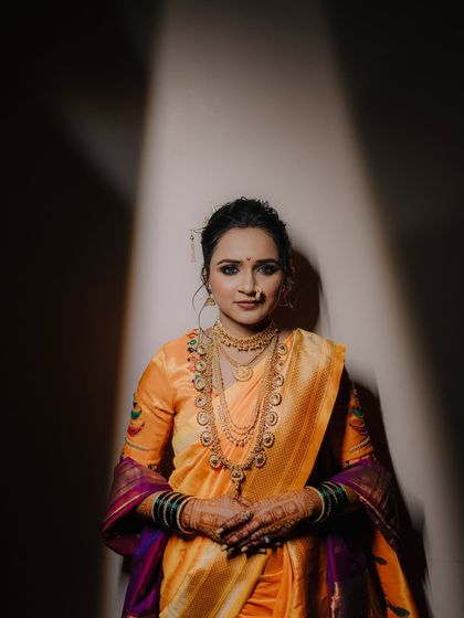 A powerful and direct bridal portrait. The dramatic lighting and the bride's confident gaze make this a striking and memorable shot.