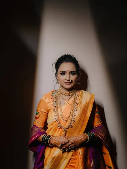 A powerful and direct bridal portrait. The dramatic lighting and the bride's confident gaze make this a striking and memorable shot.