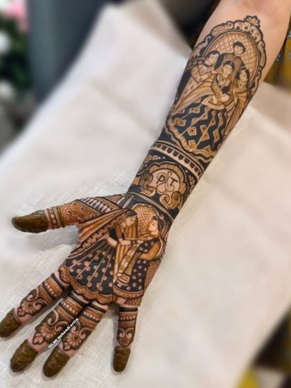 A full-arm design featuring a couple portrait on the palm and a family portrait on the arm, personalized with initials.