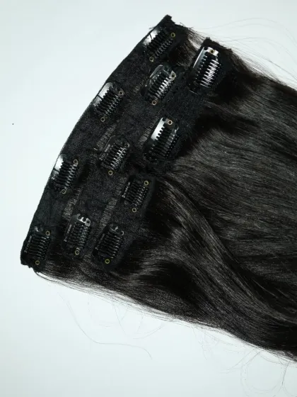 It's as easy as clip, blend, and slay. This close-up shows the sturdy clips on a weft of my jet-black extensions, ready to give you a glamorous look in minutes.