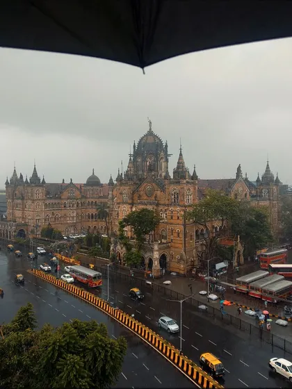 Looking down on the magnificent CSMT station from under the shelter of an umbrella. The rain gives the historic architecture a fresh, clean look.