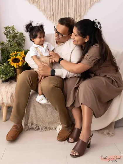 A cozy and candid moment during an indoor family session. The neutral tones and soft lighting create a warm, intimate portrait of this beautiful family.