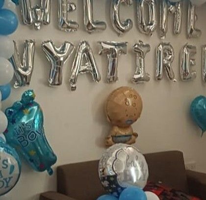 A sweet 'Welcome Home' decoration for baby Vyatirek, using silver foil letter balloons and a blue and white color scheme.