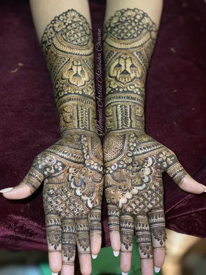 A full and intricate bridal design. The patterns are a beautiful mix of traditional motifs, creating a dense and rich look perfect for a wedding.