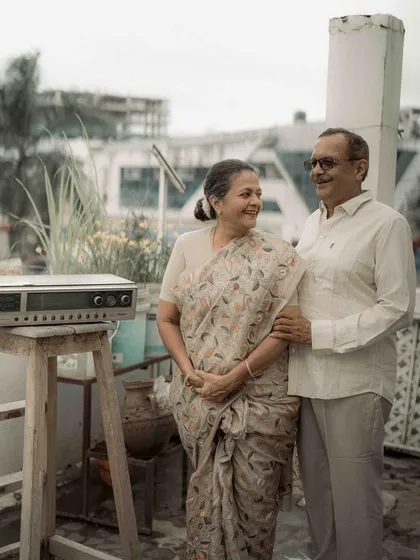 Standing on their terrace, surrounded by the life they built together. This portrait captures their shared contentment and the peaceful rhythm of their long and happy marriage.