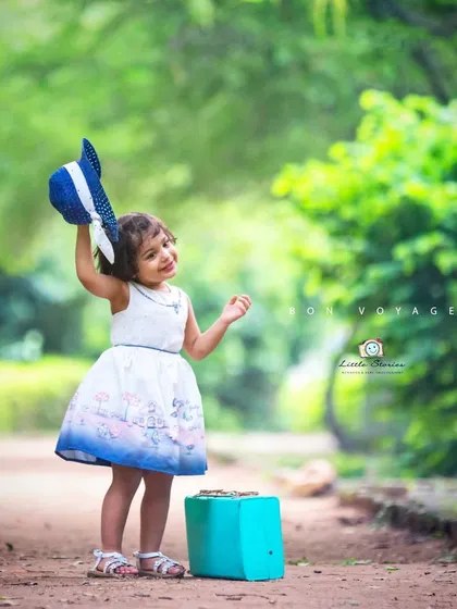 Bon voyage. This fine art portrait captures a feeling of cheerful departure and adventure, using simple props to tell a story.