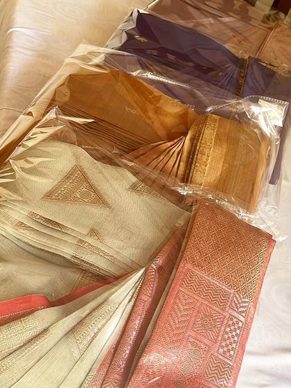 A beautiful stack of silk sarees, all box-folded and ready for storage. This is how you can keep your collection organized.