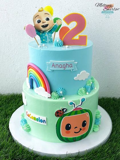 A closer look at our Cocomelon dessert table centerpiece. This two-tier cake is bright, colorful, and captures all the fun of the popular children's show, making it perfect for a second birthday bash.