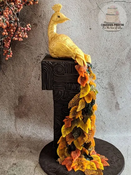 This 24-inch tall, award-winning peacock cake is one of my proudest creations. The cascading feathers, shaped like autumn leaves from delicate sugar sheets, sit atop a textured, dark chocolate fondant base, showing how I can bring a truly artistic vision to life for your special event.