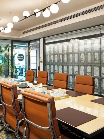 A vibrant conference room with bold patterned carpeting and custom wall graphics. This space is designed to spark creativity and energy during collaborative sessions.
