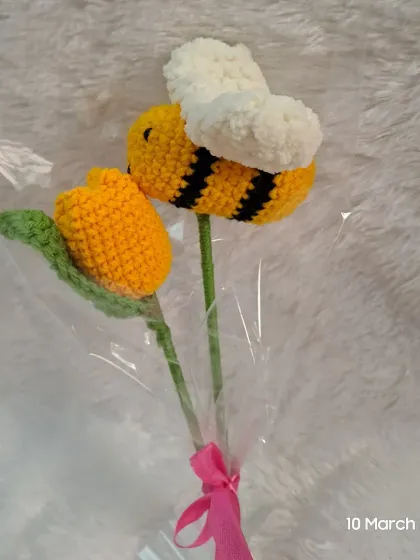 A whimsical honeybee and tulip bouquet. This playful design combines a cute amigurumi bee with a bright yellow tulip for a truly unique floral gift.