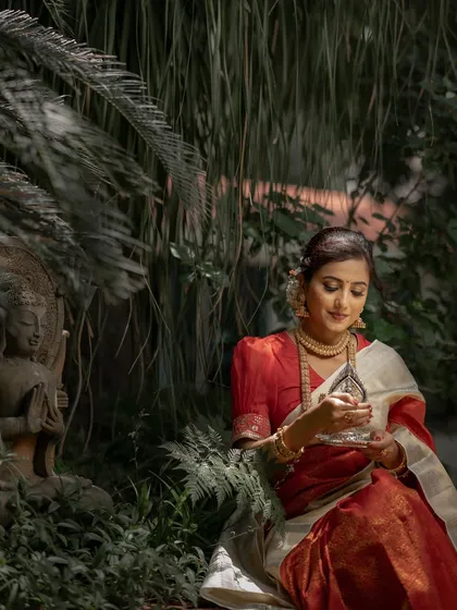 Holding a traditional silver lamp, our model embodies the sanctity of the wedding ceremony. This Kanchipuram silk saree is designed for moments of reverence and celebration.