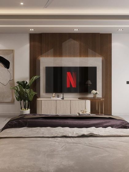 This view of the luxury bedroom interior shows the integrated media wall. The television is seamlessly incorporated into the wood paneling, maintaining the room's clean and uncluttered aesthetic while providing modern entertainment options.