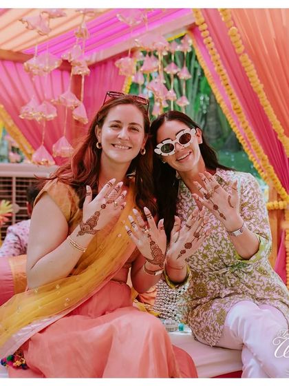 Guests showing off their fresh Mehendi designs. I ensure there are enough artists and comfortable seating so everyone who wants to can participate in the tradition.