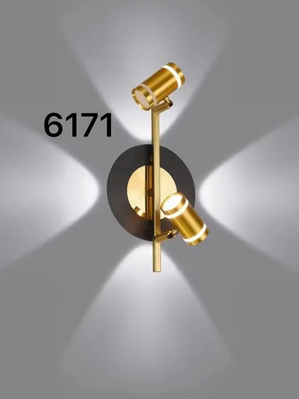 A dual-head spotlight in a black and gold finish. This type of fixture is perfect for highlighting artwork or architectural features.