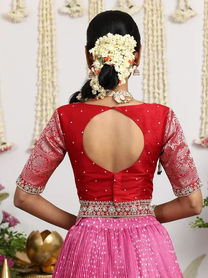 The back of the red blouse features a modern keyhole design, adding a contemporary touch to the outfit.