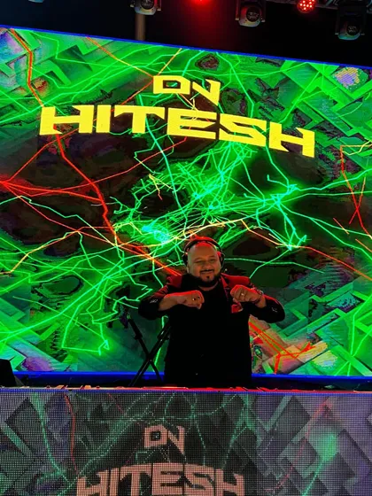 A close-up of me at the console with a vibrant green and yellow lightning visual on the LED screen. The energy is electric.