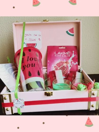 A fun and fresh 'One in a Melon' themed hamper. This trunk box includes a watermelon-themed tumbler, a face mask, and other small, coordinated gifts.
