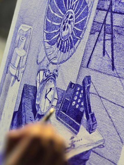 The details make the difference. This macro shot shows the intricate line work of a ballpoint pen drawing, capturing the textures of a vintage fan, clock, and telephone.