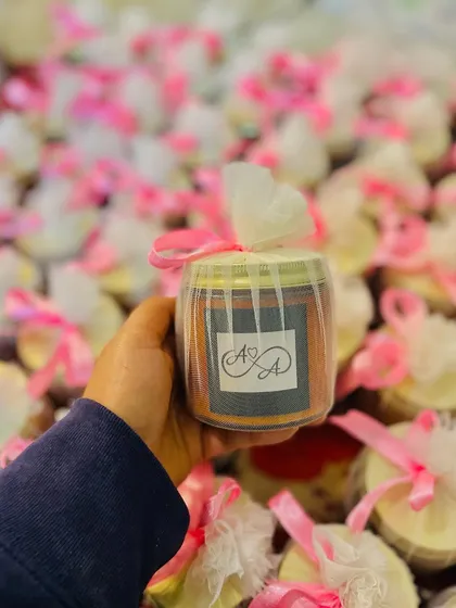 A custom candle created for Apoorva and Aditya's wedding. The personalized monogram on the label adds a special touch to these jar candle favors.