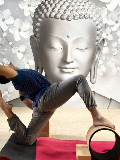 Using a yoga wheel and blocks to support an advanced backbend, allowing for a deeper and more therapeutic opening.